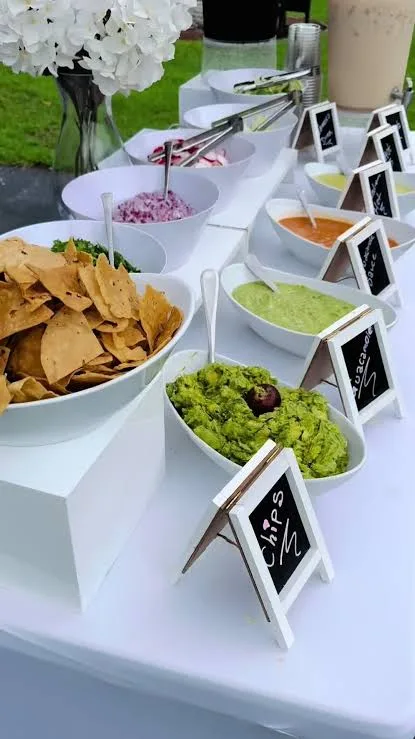 Chips, guacamole and salsa bar set up at a catered event by Delicias Factory